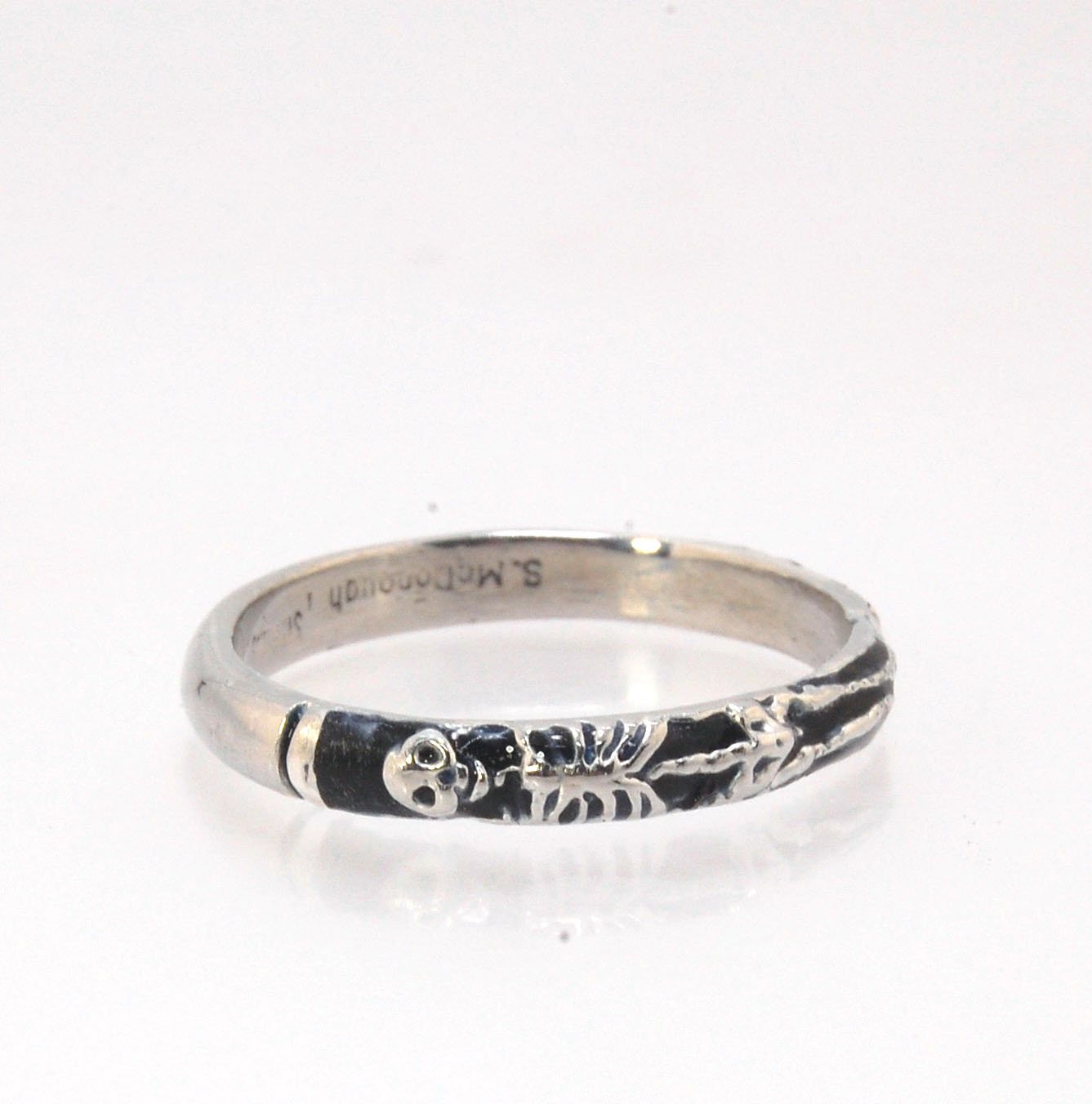 Memento Mori Skeleton Ring - Narrow -2.7mm -Enameled This is the most narrow of my Memento Mori rings at 3mm wide. The Skelton is flanked by intertwined hearts on one side. Each ring in this collection is carved in wax by hand and cast using the ancient l