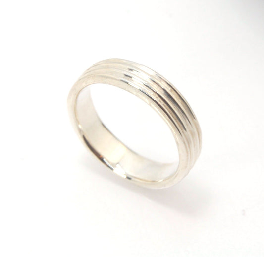 4 Rim Heavy Band 6mm wide - in Gold or Silver This is a heavy band cast from a wax carving turned on a lathe. These are so much fun to make! I have several different variations of this design.6mm wide and 2 mm thickThis ring is pictured in sterling silver