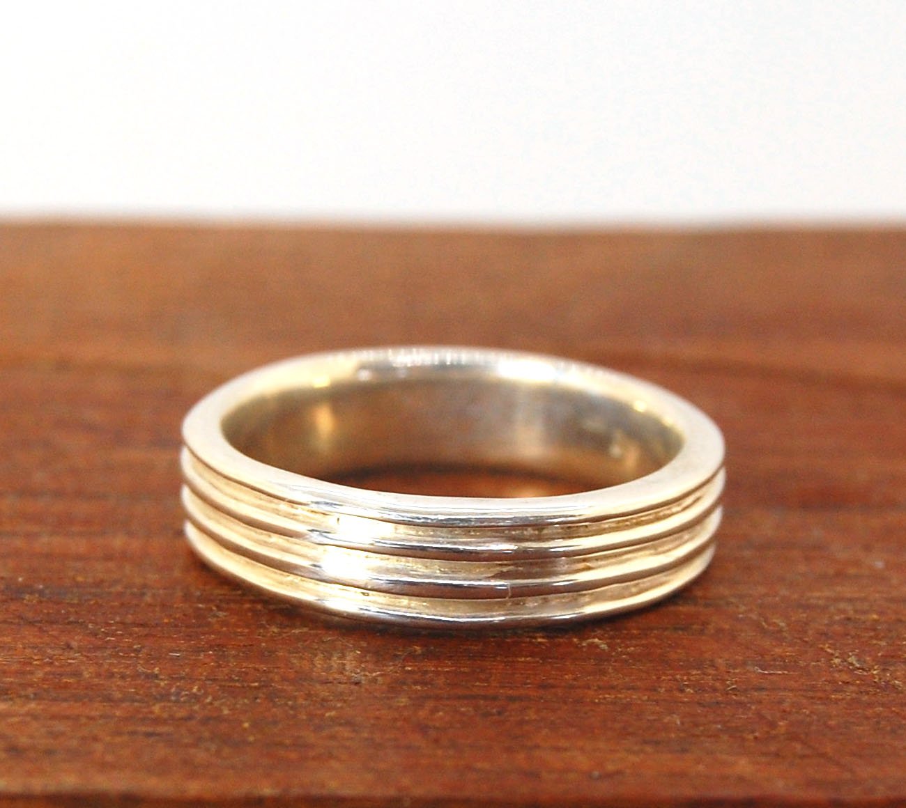 4 Rim Heavy Band 6mm wide - in Gold or Silver This is a heavy band cast from a wax carving turned on a lathe. These are so much fun to make! I have several different variations of this design.6mm wide and 2 mm thickThis ring is pictured in sterling silver