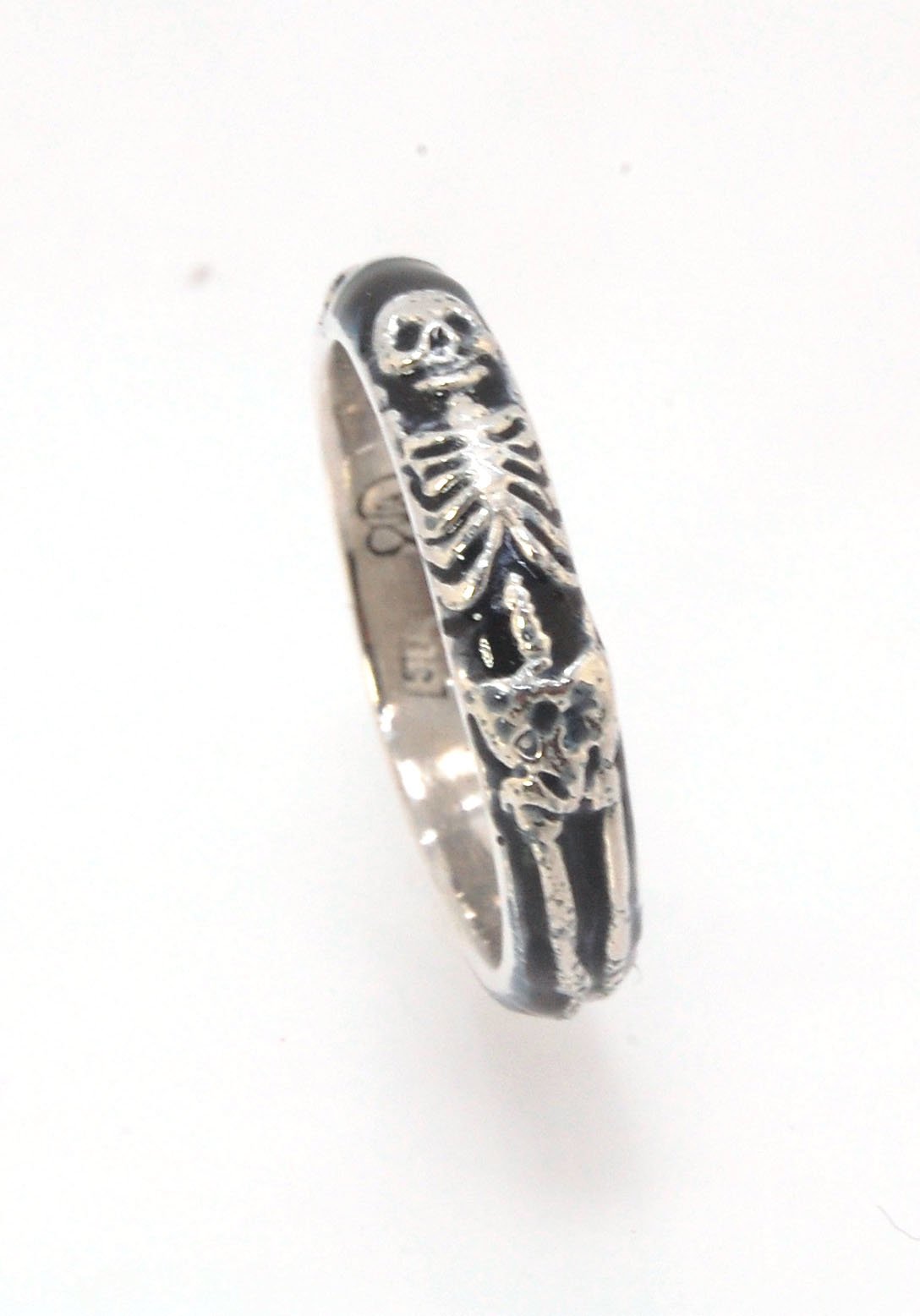 Memento Mori Skeleton Ring - Medium - 4mm - Enameled This is the middle width of my Memento Mori skeleton rings at 4mm wide. The Skeleton is flanked by crossed bones on one side and an hourglass on the other. Each ring in this collection is carved in wax