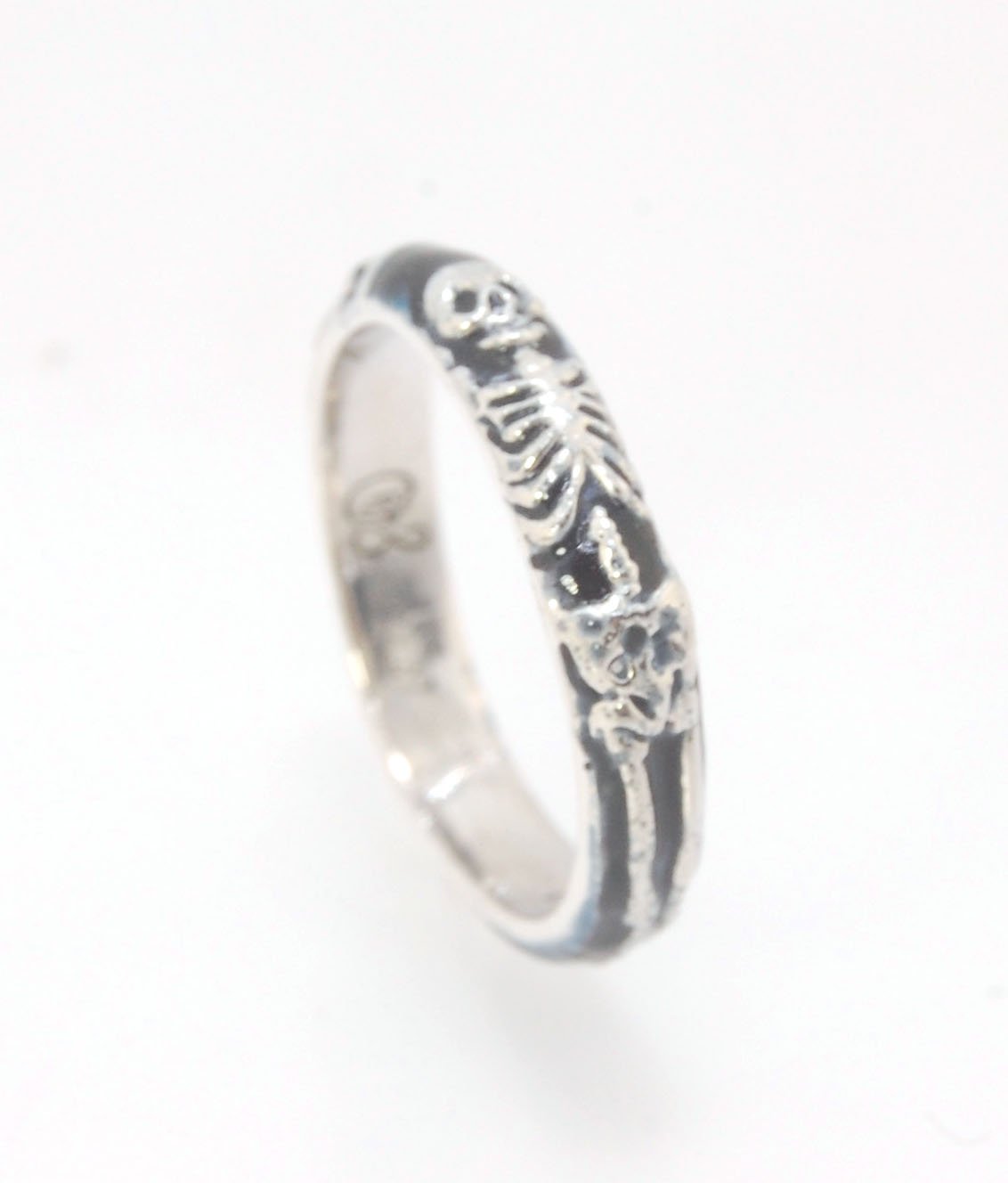 Memento Mori Skeleton Ring - Medium - 4mm - Enameled This is the middle width of my Memento Mori skeleton rings at 4mm wide. The Skeleton is flanked by crossed bones on one side and an hourglass on the other. Each ring in this collection is carved in wax