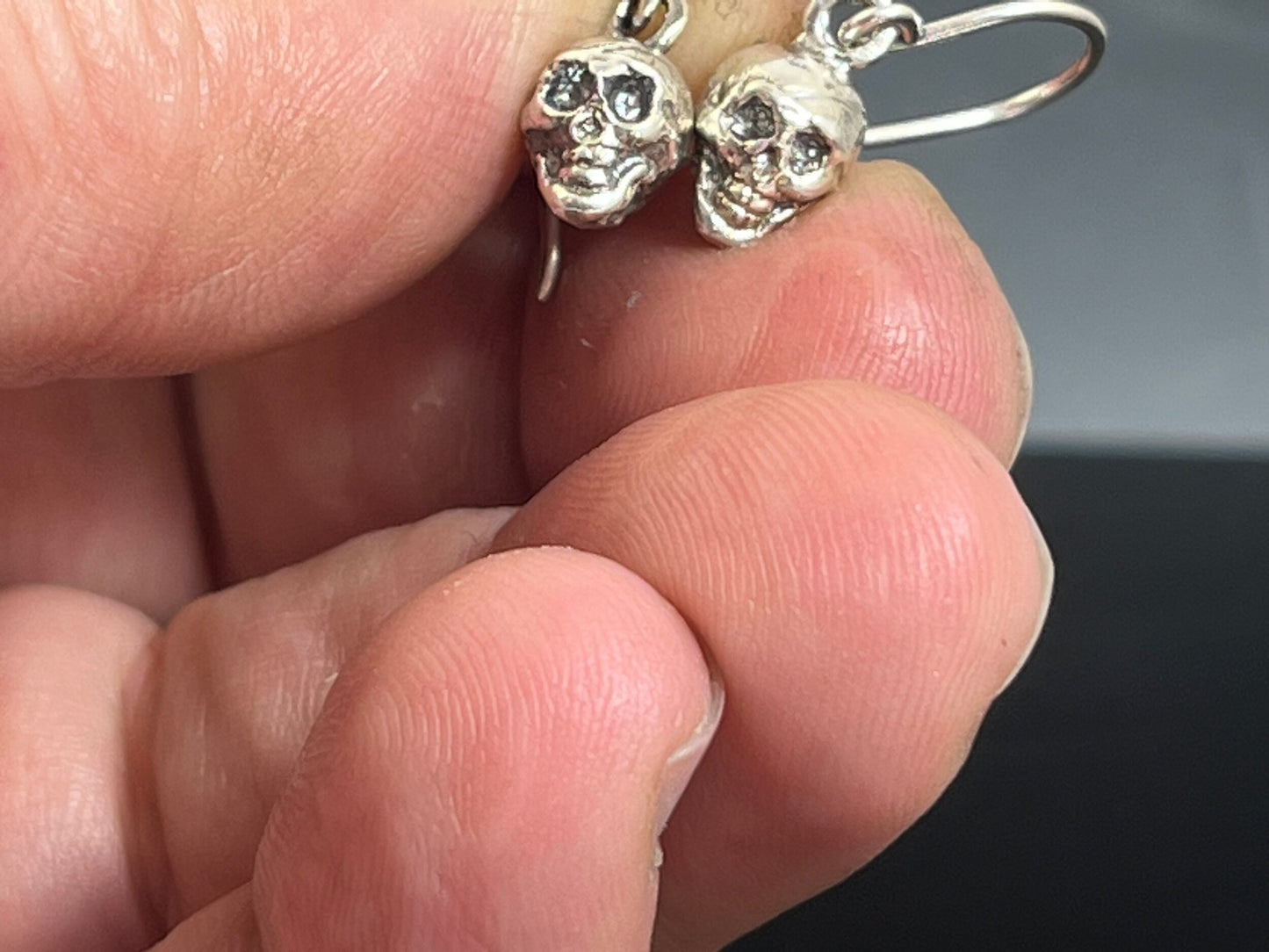 Skull Dangle Earrings This solid sterling silver Skull Pendant is wax carved by hand and cast using the ancient process of Lost Wax casting. I then made a mold, which I can inject with wax and make wax copies of the Jolly Roger Pendant and cast a lot of t