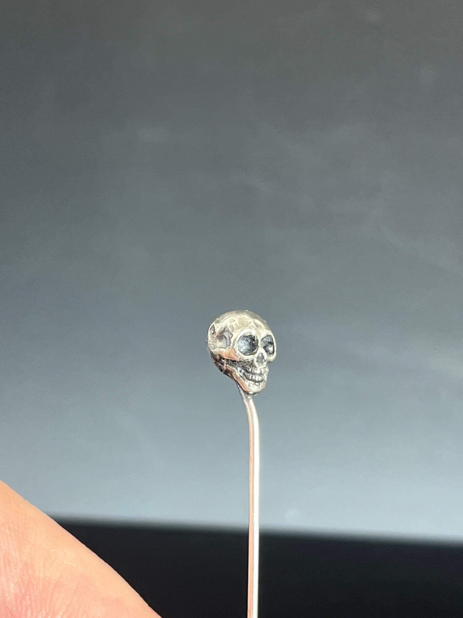 Yorick Skull Stick Pin This Skull Stick Pin is just darling if you like weird stuff. This Skull is wax carved by hand and cast using the ancient process of Lost Wax to cast them in sterling silver. I then made a mold, which I can inject with wax and make