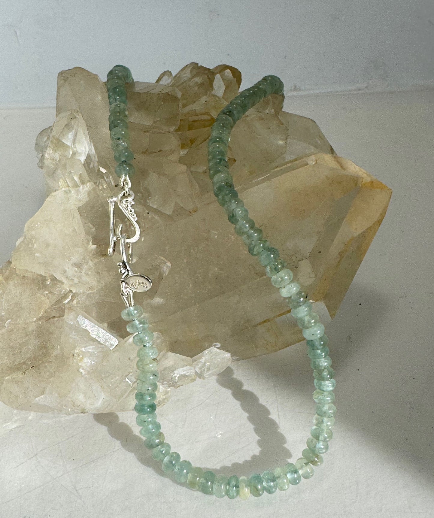 Aquamarine Gemstone Bead Strand with Granulated Sterling Silver safety clasp These ocean-colored Aquamarine rondelle gemstone beads are just lovely on! These beauties have a nice weight and warmth. I have made a sterling silver two-part safety clasp with