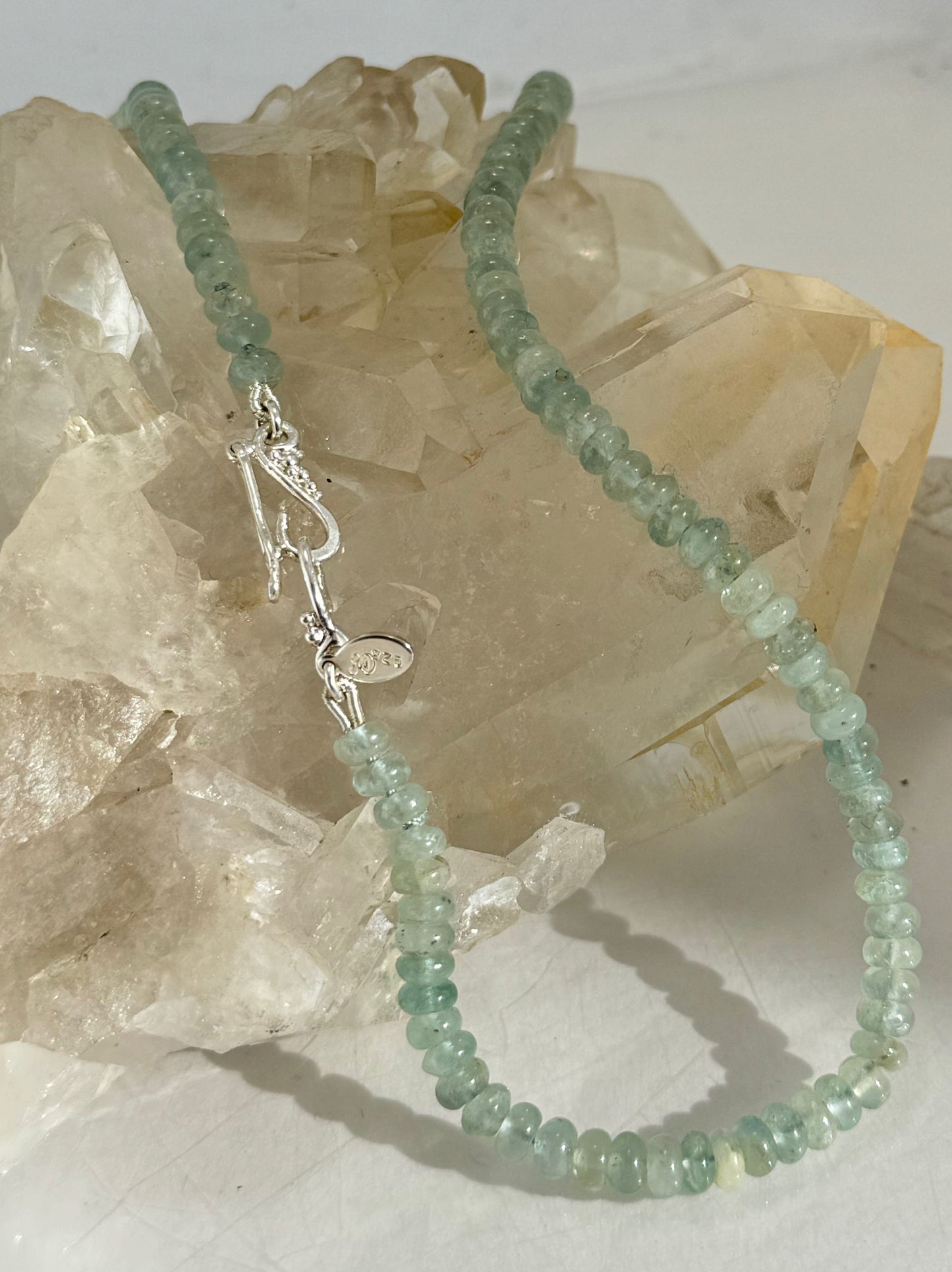 Aquamarine Gemstone Bead Strand with Granulated Sterling Silver safety clasp These ocean-colored Aquamarine rondelle gemstone beads are just lovely on! These beauties have a nice weight and warmth. I have made a sterling silver two-part safety clasp with