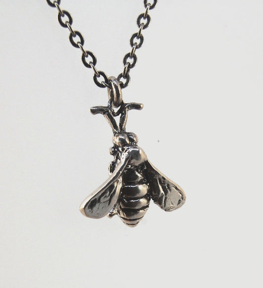 Bee Necklace in Sterling Silver Bee Necklace in Sterling Silver with a Sterling Chain and clasp.These bees were so fun to carve!Carved in wax and cast using a lost-wax process in Sterling Silver. I have made a mold of the first bee so I can make more bees