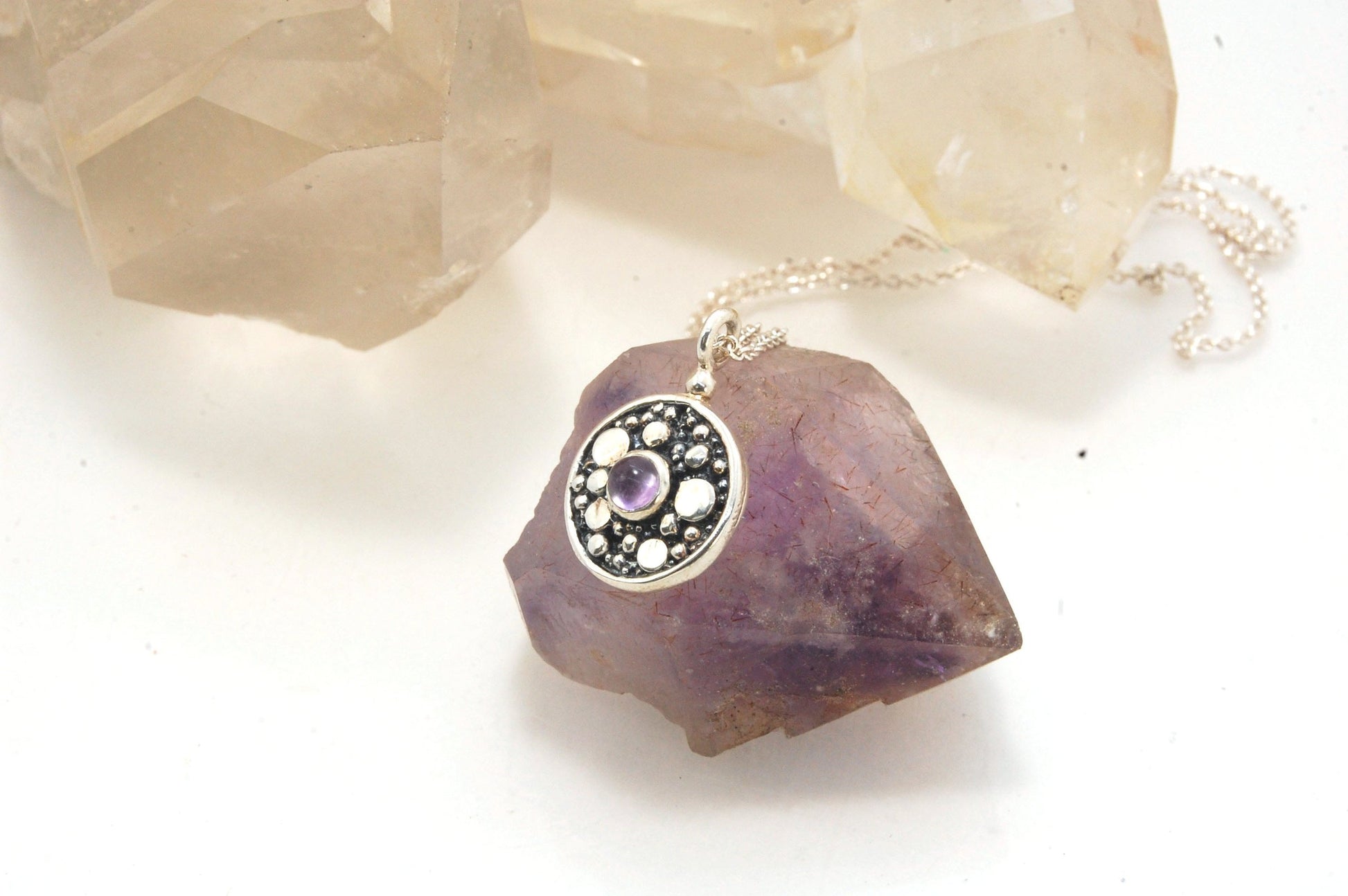 Cluster Charm in Sterling Silver with Moonstone, Iolite, Amethyst, or Garnet This sweet Cluster Charm is a Sterling Silver cast from a Fine Silver granulated original. You can choose from several stones for the center: Moonstone, Iolite , Amethyst, or Gar