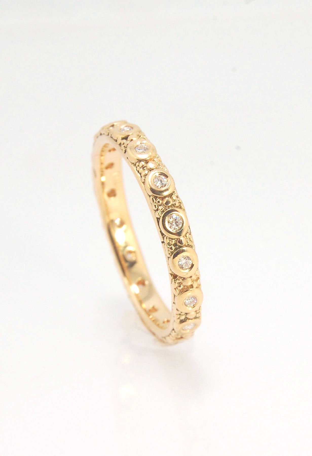 Diamond Eternity Band - Order in 14k, 18k or Sterling Silver The subtle sparkle of this band is a delight! This is a 3mm patterned band with ethically sourced, 1.5 mm SI2-SI3 F+ Round Diamonds bezel set in each disc around the band. This is a cast version