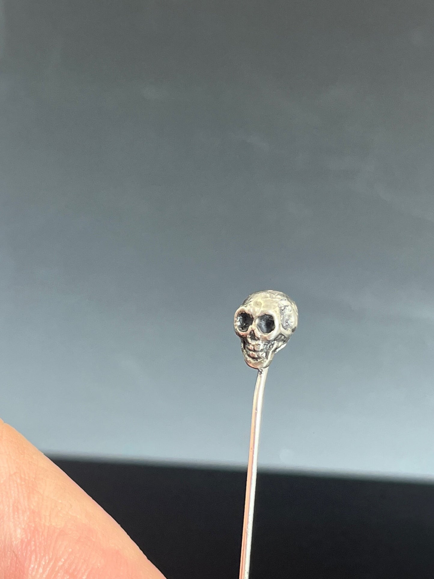 Yorick Skull Stick Pin This Skull Stick Pin is just darling if you like weird stuff. This Skull is wax carved by hand and cast using the ancient process of Lost Wax to cast them in sterling silver. I then made a mold, which I can inject with wax and make