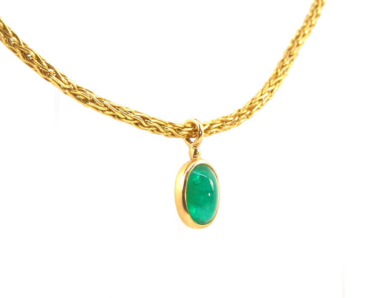 Emerald Cabochon on Handmade Woven 18k gold chain This clear emerald cabochon is bezel-set in 18k gold and suspended from a handmade woven chain of 18k gold in ancient Viking knit. A forged hook clasp finishes this simple and elegant design. Emerald Caboc