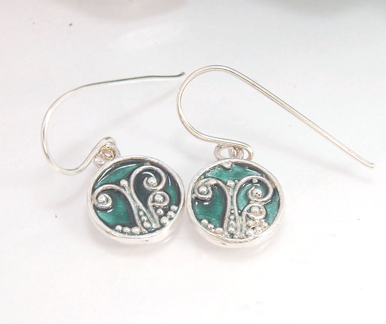 Enameled Sterling Fern Earrings -Circle -Medium These are my medium fern circles and they can be enameled in 8 colors for you!Prussian Blue, Icy Blue, Turquoise, Oil Gray, Forest Green, Jade Green, Sage Green or Periwinkle BlueGreen.These enameled 11mm ov