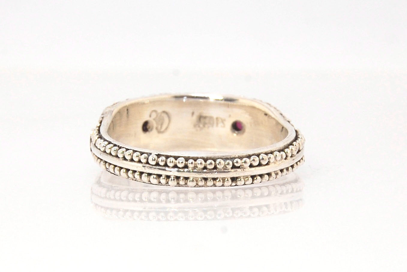 Rhodolite Garnet Shield Ring with Granulation in Fine Silver Rhodolite Garnet Cabochons bezel-set in fine silver granulation with large circles and a granulated shank. Granulation is a controlled fusing process that has been utilized for thousands of year