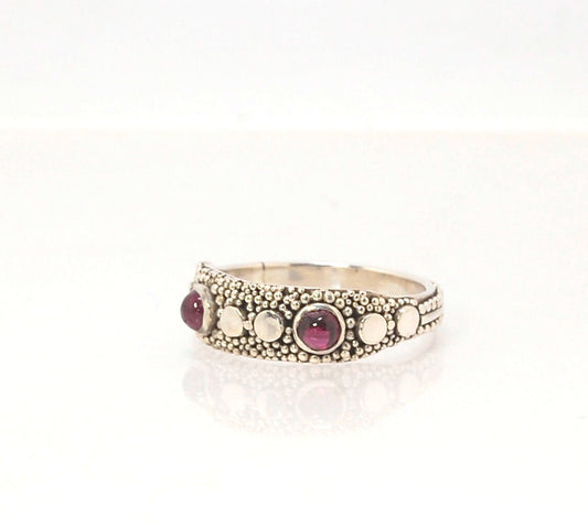 Rhodolite Garnet Shield Ring with Granulation in Fine Silver Rhodolite Garnet Cabochons bezel-set in fine silver granulation with large circles and a granulated shank. Granulation is a controlled fusing process that has been utilized for thousands of year