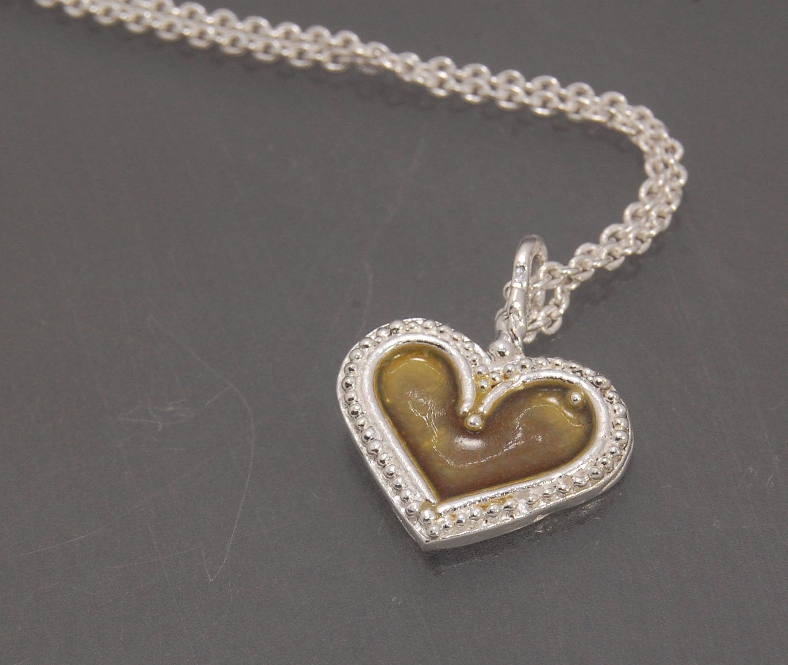 Enamel Heart Charm in Fine SIlver It’s a HEART of fine silver granulation that I made a mold of, then cast, then enameled! In your choice of colors: Red, Purple, Green, Black, Azalea, HollyhockGranulation is an ancient fusing process utilized for thousand