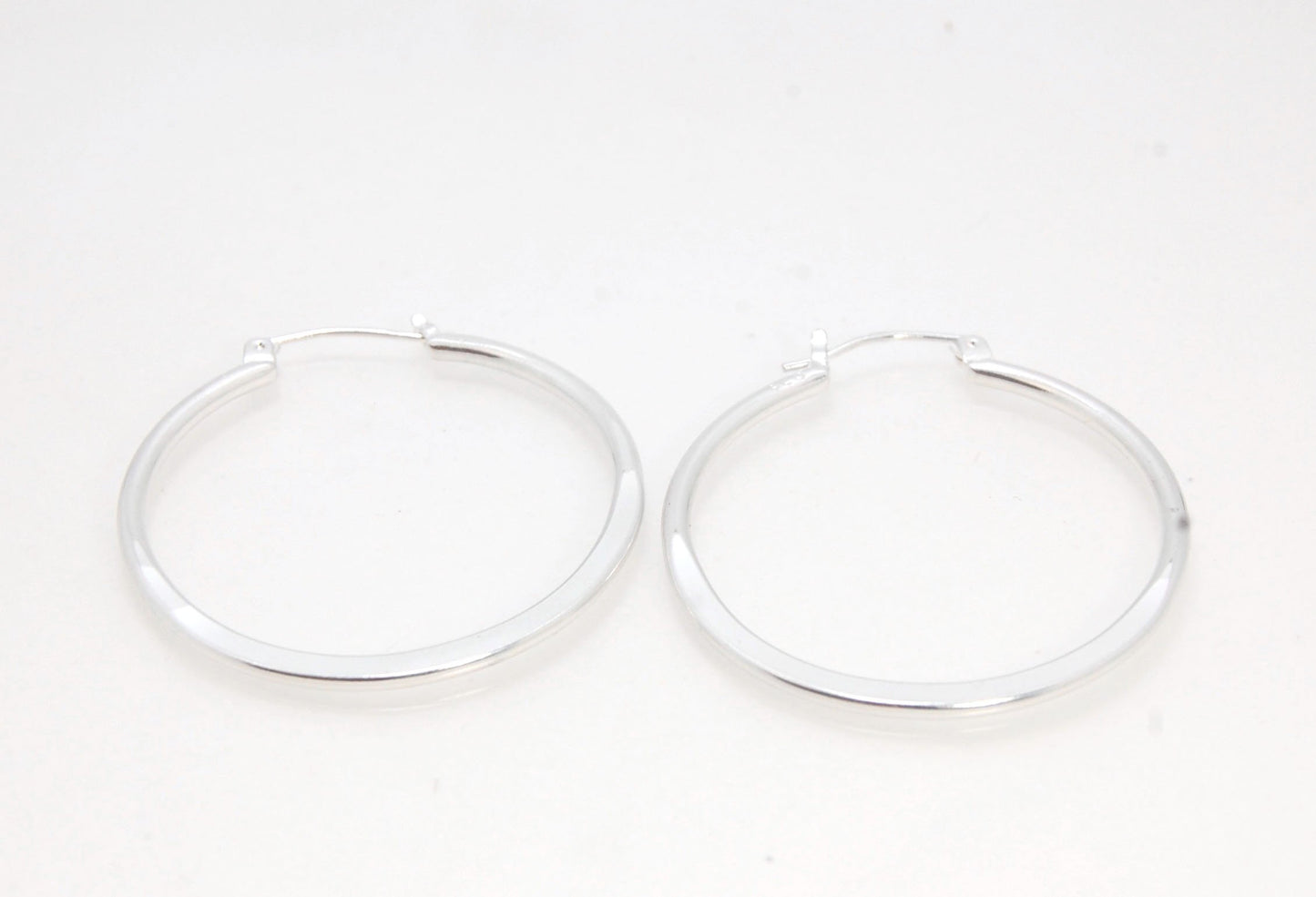 Hammer Forged Hoops - Large - Sterling These are Classic hammer-forged hoop earrings. These elegant hoops have a secure hoop catch with a satisfying snap. They are secure, lightweight and comfortable enough to wear everyday! You may even sleep in them!The