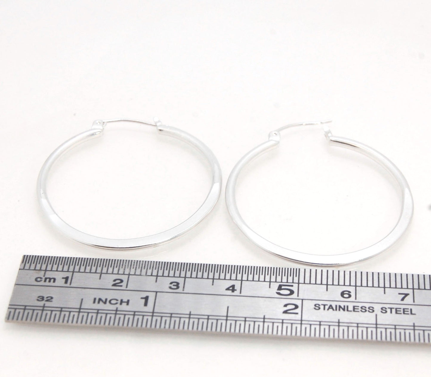 Hammer Forged Hoops - Large - Sterling These are Classic hammer-forged hoop earrings. These elegant hoops have a secure hoop catch with a satisfying snap. They are secure, lightweight and comfortable enough to wear everyday! You may even sleep in them!The