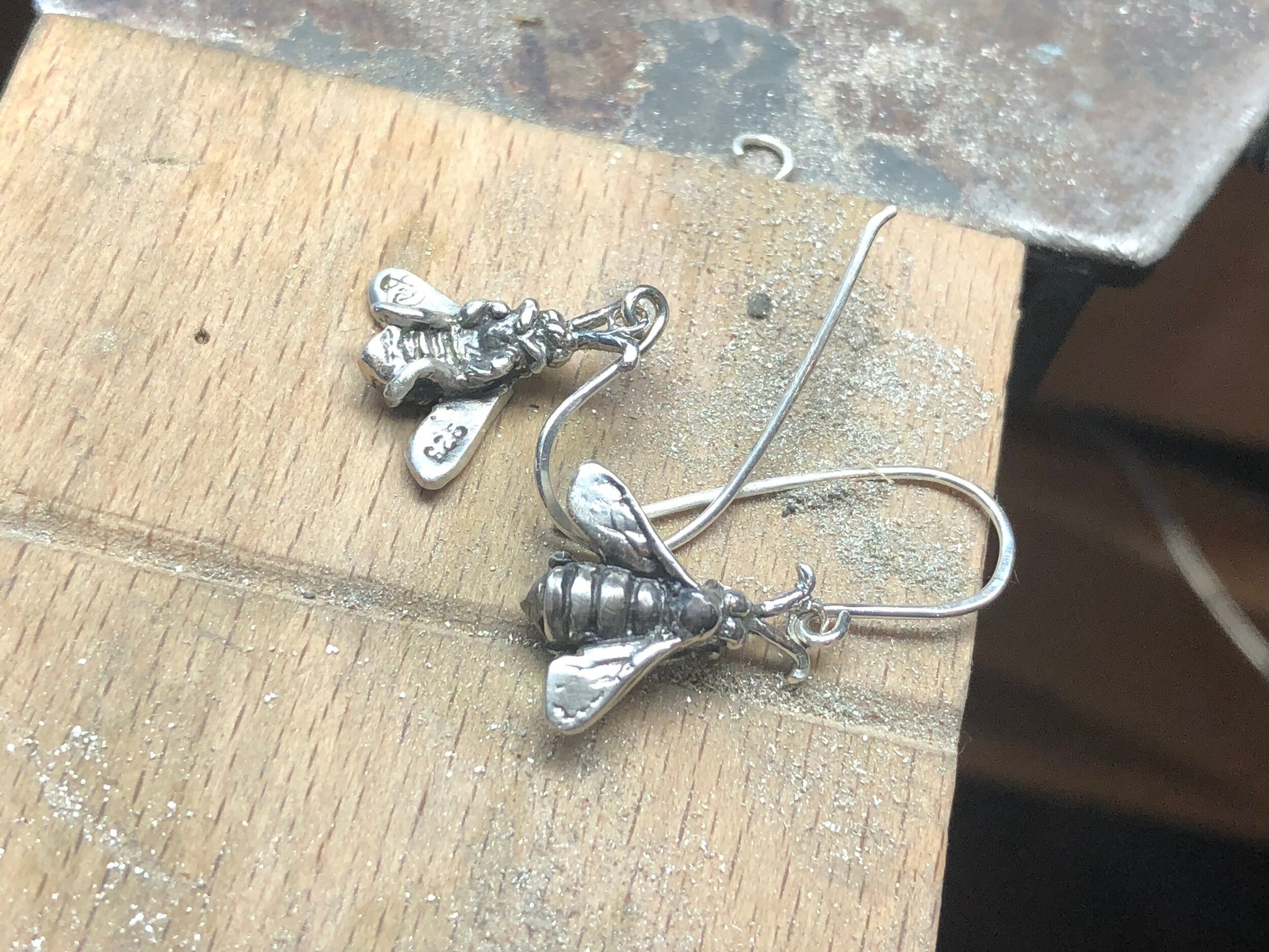 Bee Earrings in Sterling Silver Bee Earrings in Sterling Silver with a French Hook. These bees were so fun to carve!I carved the original bee in wax and then cast it using a lost wax process in sterling. I then made a mold of the sterling bee. Then inject