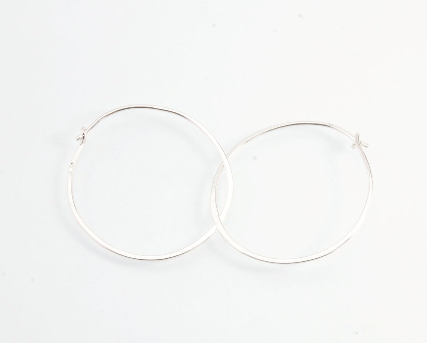 Hammered Hoops - Sterling - Small, Medium and Large Looking for an affordable handmade gift? Or some super lightweight Sterling Silver Hoops you can live in? These classic wire hammered hoops you can sleep and live in are forged from 20 gage Sterling wire