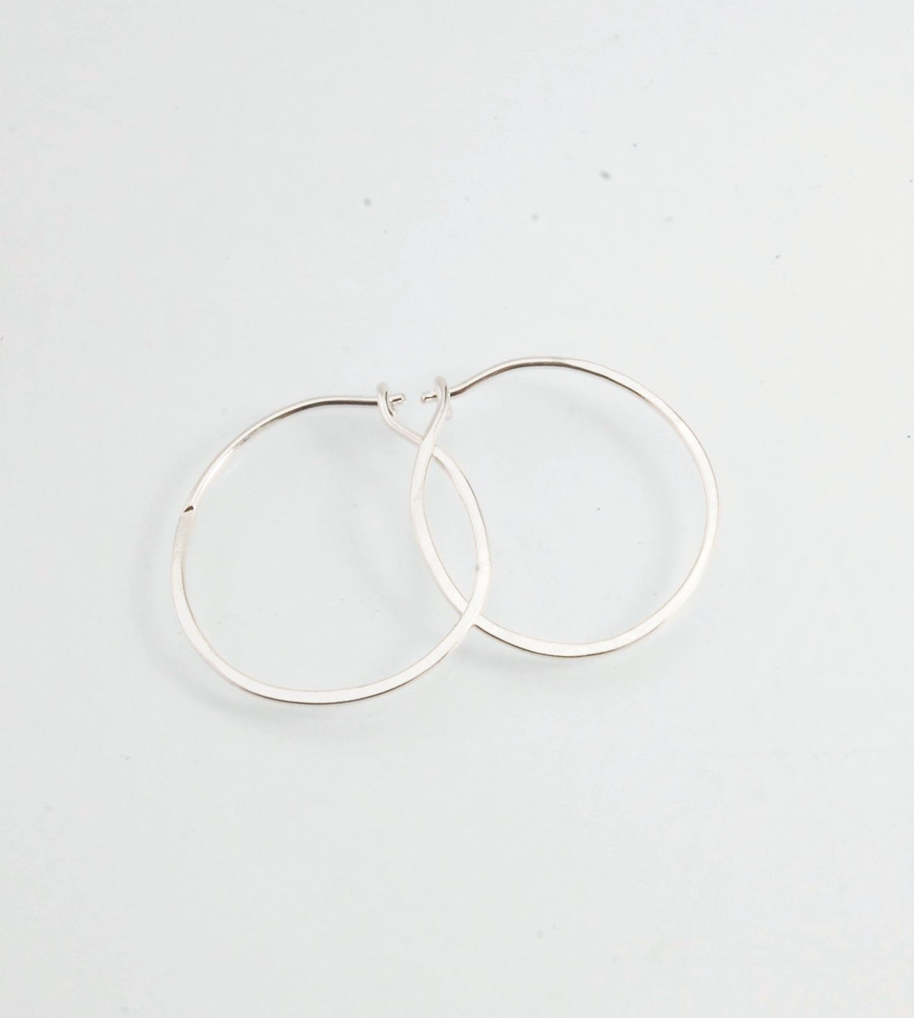 Hammered Hoops - Sterling - Small, Medium and Large Looking for an affordable handmade gift? Or some super lightweight Sterling Silver Hoops you can live in? These classic wire hammered hoops you can sleep and live in are forged from 20 gage Sterling wire