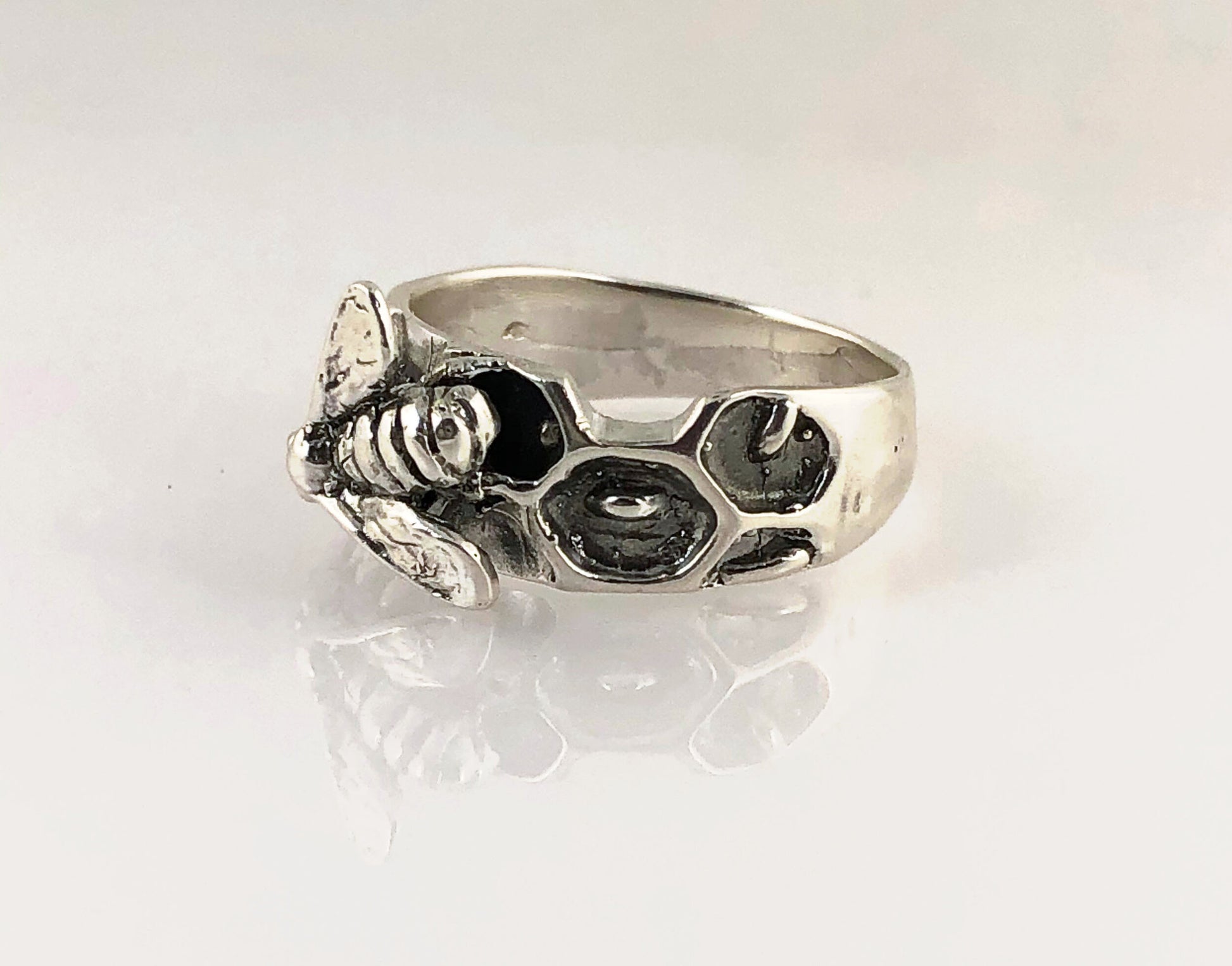 Milk Brood Bee Ring Carved in wax and cast in Sterling Silver, this Milk Brood Bee Ring has carved honeycomb cells with the Future of the Hive just starting! Baby Bee larvae look a lot like tiny grubs. Beekeepers call larvae uncapped brood or “milk brood”