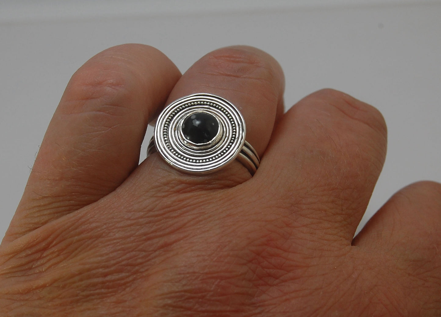 Orbit Ring with Snowflake Jasper Snowflake Jasper Cabochon bezel-set in fine silver granulation with concentric rings and a sterling silver shank cast from an original wax turned ring cast on site. Granulation is a controlled fusing process that has been