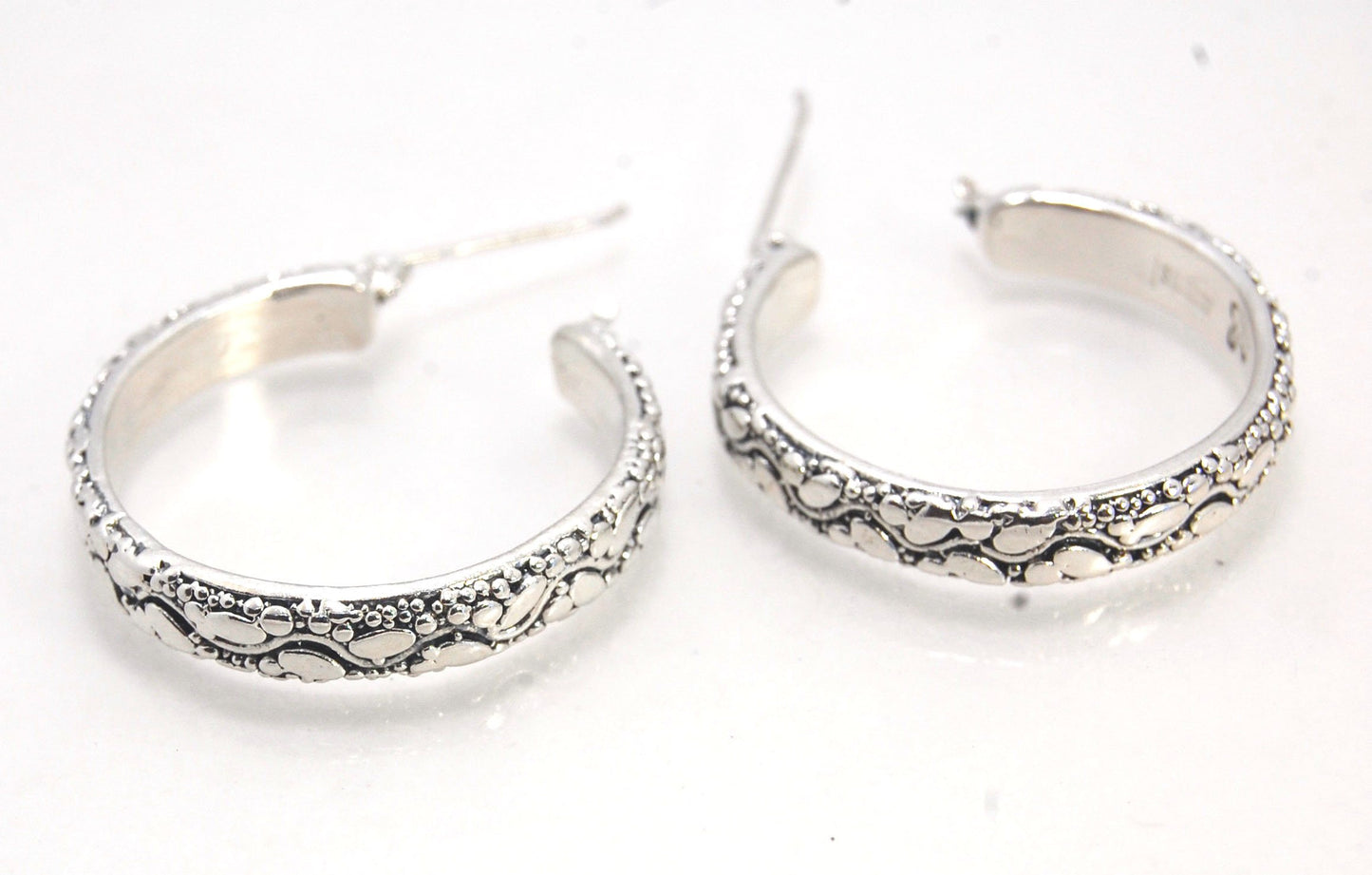 Oval Dots Hoop Earrings - Sterling Silver in 3 sizes These Hoops are made from an Oval and Dot pattern 4.7 mm wide band with ovals and heavy granules around a wavy center line. I made the original band in Fine silver using the process of Granulation. I th