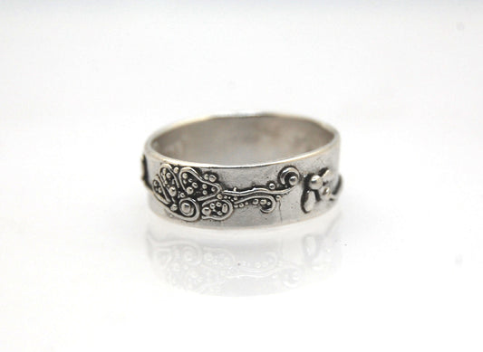 Pollinator Ring This Pollinator Band has a Bee and flower in tiny granulation. This band is a cast from a mold taken of a ring I granulated in fine silver. Granulation is an ancient fusing process that can only be done in certain highly pure metals that w