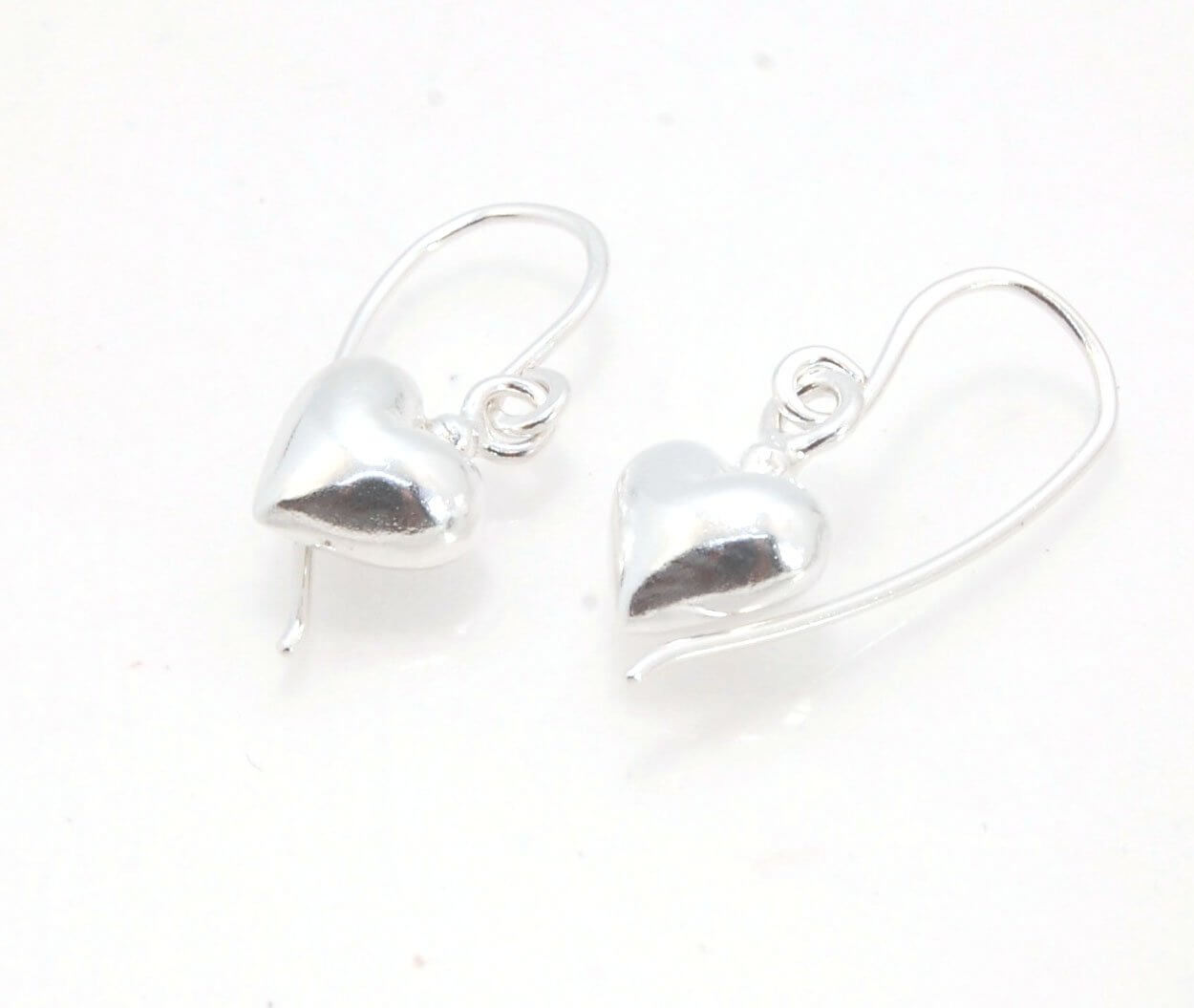 Puffy Heart Dangles - Large - Oxidized These terrific heart dangle earrings are cast from a wax carved original and are cast using the lost wax process. I then make a mold, then a wax copy, and through the process of lost wax casting I make these cast ear