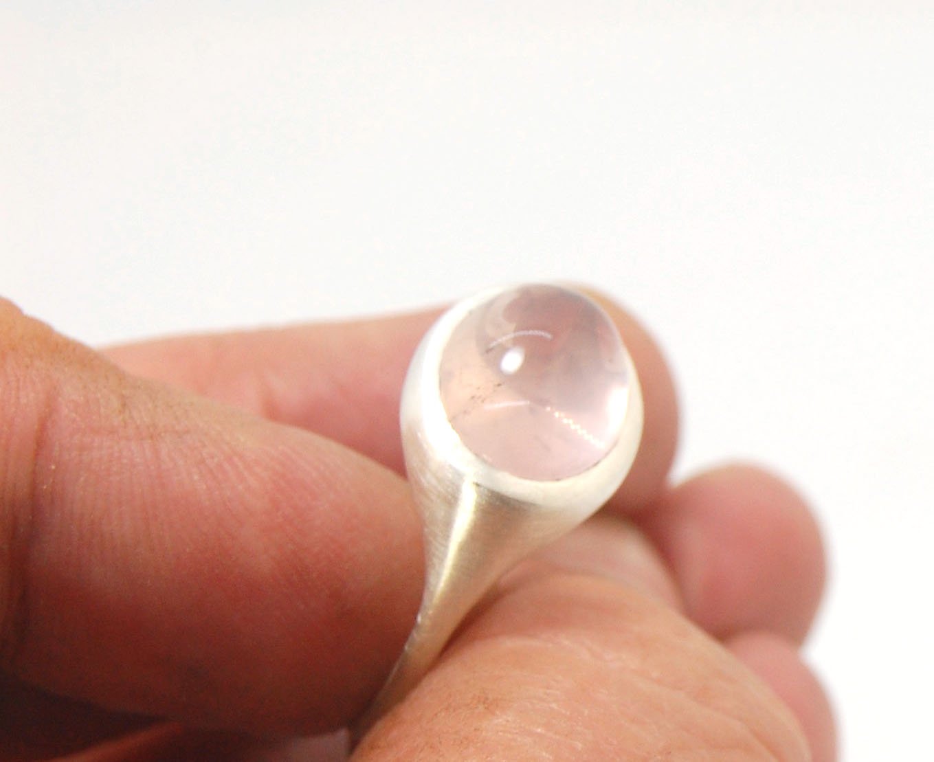 Rose Quartz Ring in Brushed Silver This is one of my first wax carved designs cast in sterling silver using a lost wax process. I start with a piece of wax and math and start carving until the ring is revealed! The back of the rIng is fully open so the ro