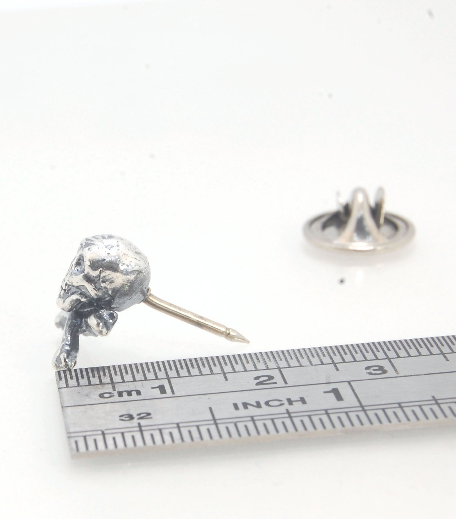 Skull & Bones Tie Tack Lapel Pin This solid sterling silver Skull & Bones tie tack label pin is wax carved by hand and cast using the ancient process of Lost Wax in sterling silver. I then made a mold, which I can inject with wax and make wax copies of th