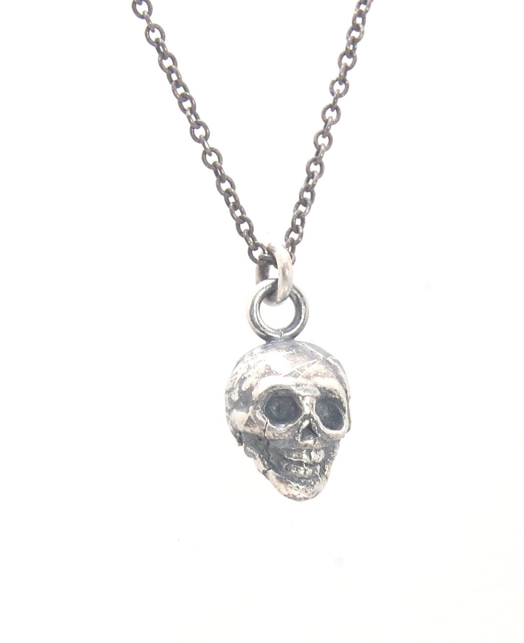 Tiny Skull Charm Pendant This solid sterling silver Skull Pendant is wax carved by hand and cast using the ancient process of Lost Wax casting. I then made a mold, which I can inject with wax and make wax copies of the Jolly Roger Pendant and cast a lot o