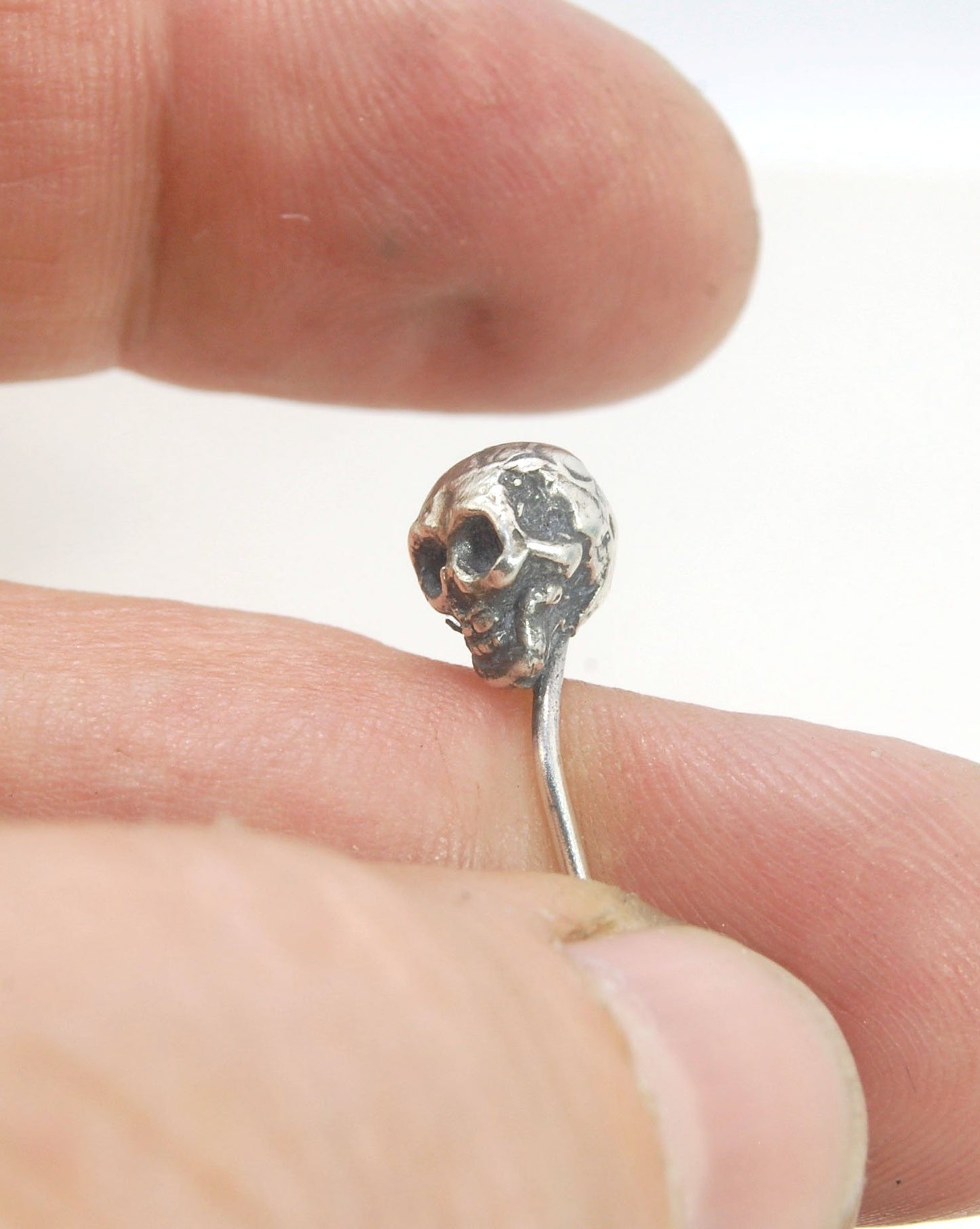 Yorick Skull Stick Pin This Skull Stick Pin is just darling if you like weird stuff. This Skull is wax carved by hand and cast using the ancient process of Lost Wax to cast them in sterling silver. I then made a mold, which I can inject with wax and make