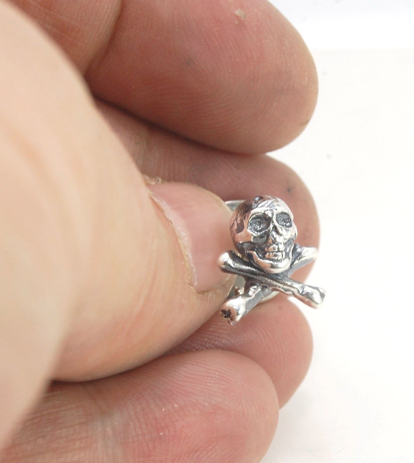 Skull & Bones Tie Tack Lapel Pin This solid sterling silver Skull & Bones tie tack label pin is wax carved by hand and cast using the ancient process of Lost Wax in sterling silver. I then made a mold, which I can inject with wax and make wax copies of th