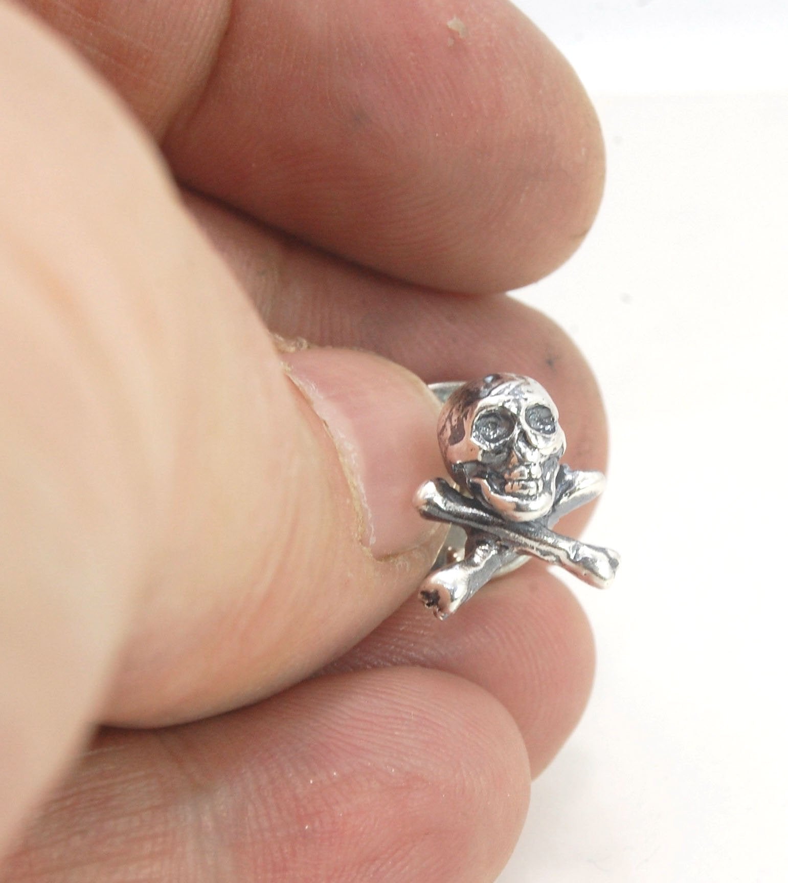 Skull & Bones Tie Tack Lapel Pin This solid sterling silver Skull & Bones tie tack label pin is wax carved by hand and cast using the ancient process of Lost Wax in sterling silver. I then made a mold, which I can inject with wax and make wax copies of th