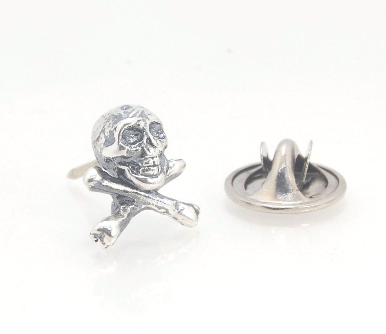 Skull & Bones Tie Tack Lapel Pin This solid sterling silver Skull & Bones tie tack label pin is wax carved by hand and cast using the ancient process of Lost Wax in sterling silver. I then made a mold, which I can inject with wax and make wax copies of th