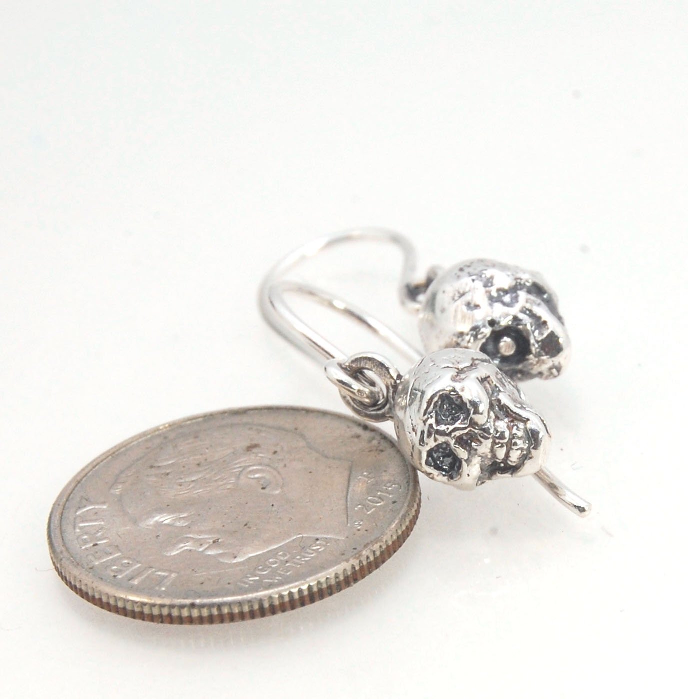 Skull Dangle Earrings This solid sterling silver Skull Pendant is wax carved by hand and cast using the ancient process of Lost Wax casting. I then made a mold, which I can inject with wax and make wax copies of the Jolly Roger Pendant and cast a lot of t