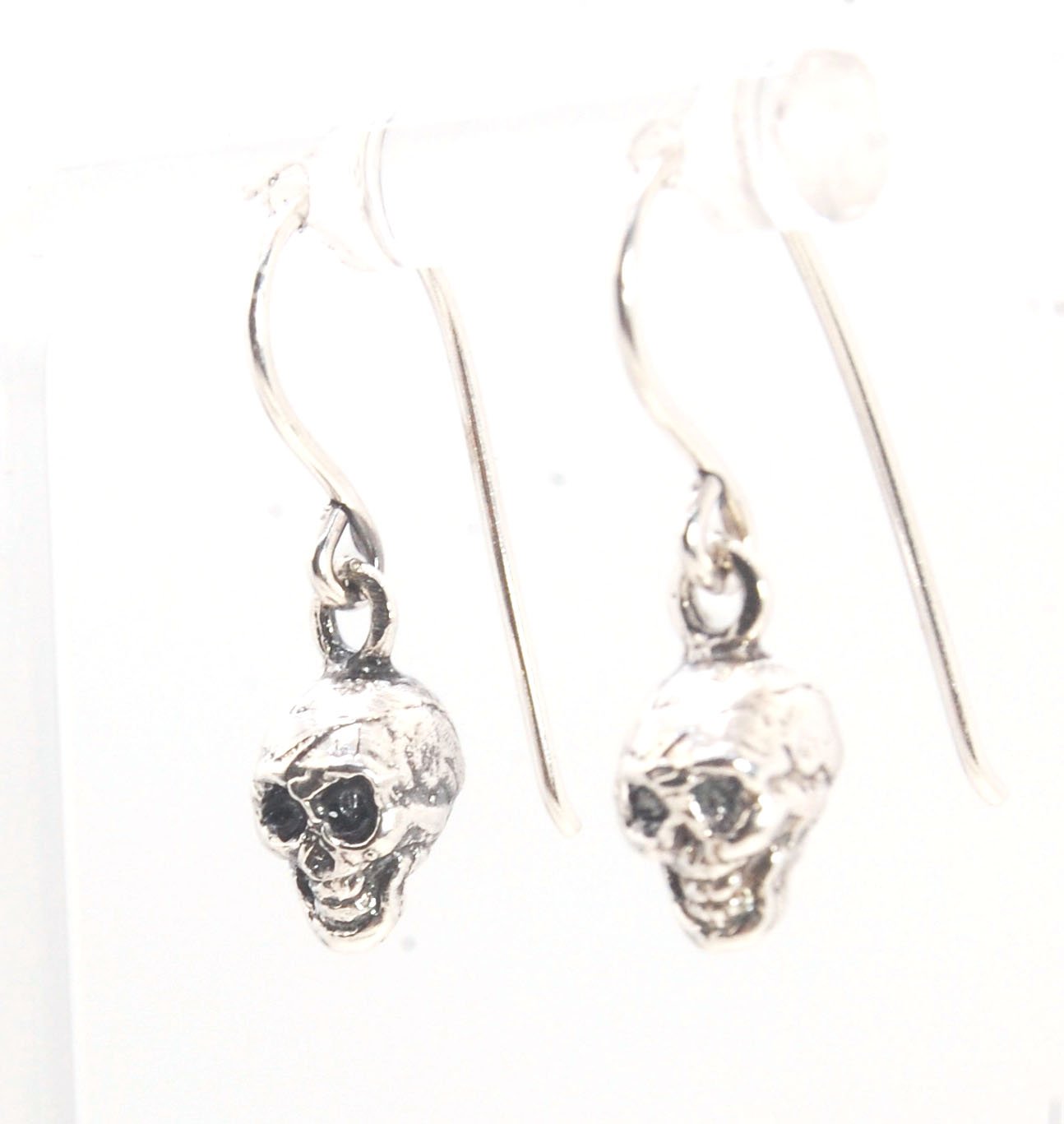 Skull Dangle Earrings This solid sterling silver Skull Pendant is wax carved by hand and cast using the ancient process of Lost Wax casting. I then made a mold, which I can inject with wax and make wax copies of the Jolly Roger Pendant and cast a lot of t