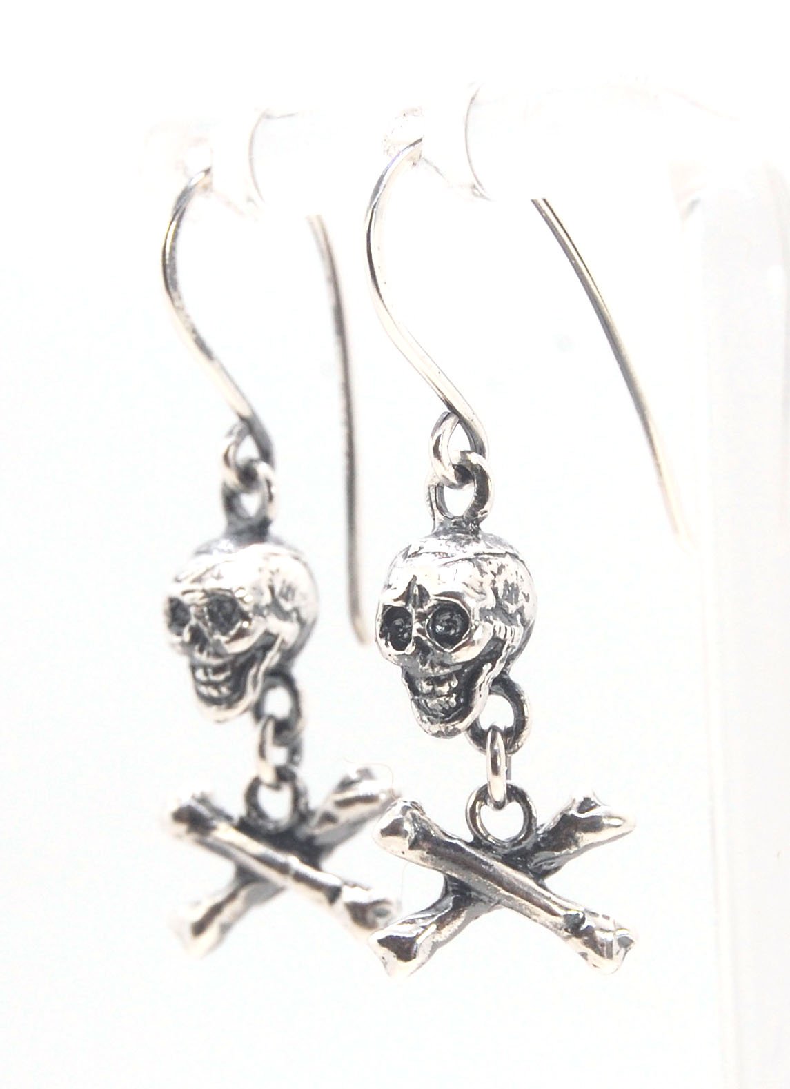 Skull & Bones Dangle Earrings These solid sterling silver Skull & Bones dangle earrings are wax carved by hand and cast using the ancient process of Lost Wax to cast them in sterling silver. I then made a mold, which I can inject with wax and make wax cop