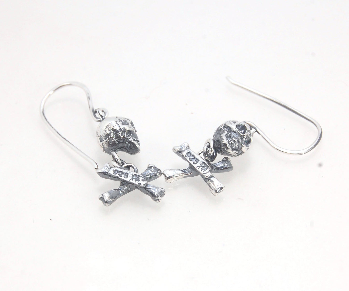 Skull & Bones Dangle Earrings These solid sterling silver Skull & Bones dangle earrings are wax carved by hand and cast using the ancient process of Lost Wax to cast them in sterling silver. I then made a mold, which I can inject with wax and make wax cop