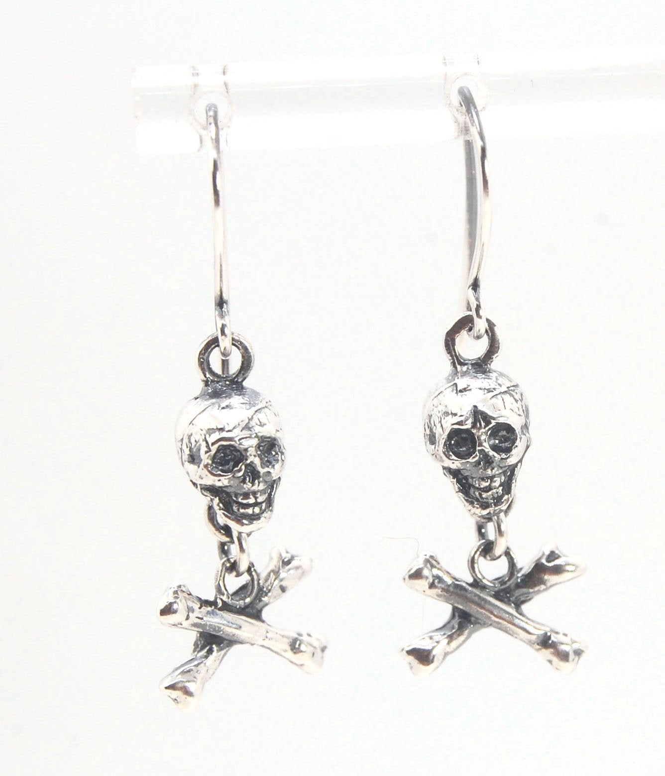 Skull & Bones Dangle Earrings These solid sterling silver Skull & Bones dangle earrings are wax carved by hand and cast using the ancient process of Lost Wax to cast them in sterling silver. I then made a mold, which I can inject with wax and make wax cop