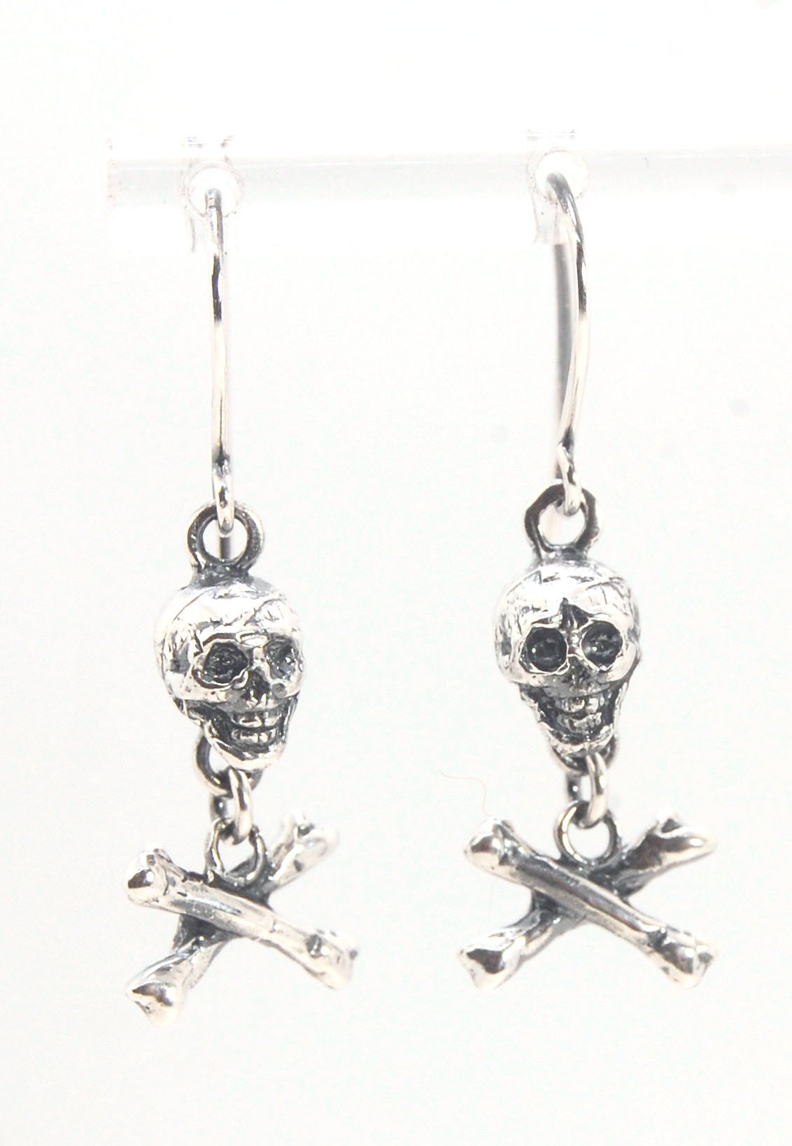 Skull & Bones Dangle Earrings These solid sterling silver Skull & Bones dangle earrings are wax carved by hand and cast using the ancient process of Lost Wax to cast them in sterling silver. I then made a mold, which I can inject with wax and make wax cop