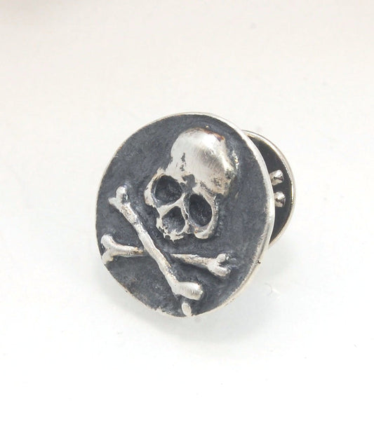 Skullbones Coin Lapel Pin These solid sterling silver SkullBones Coin Lapel Pin can also be worn as a Tie Tack. This Skullbones Coin is wax carved by hand and cast using the ancient process of Lost Wax to cast them in sterling silver. I then made a mold,