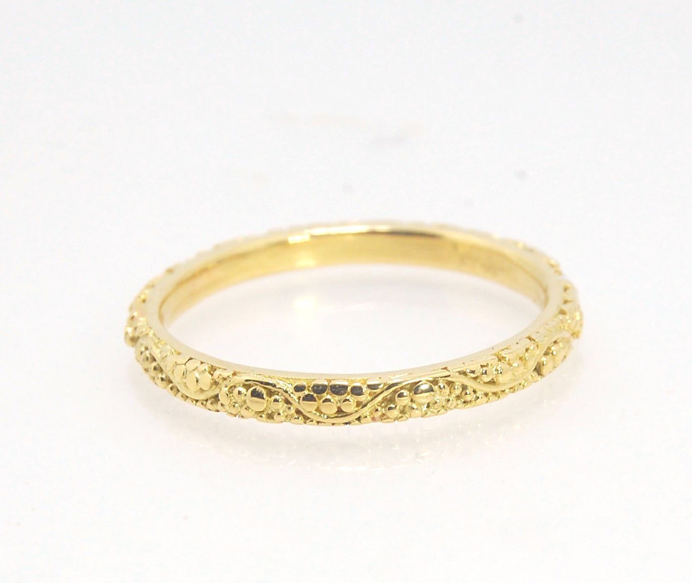 Twining Band in 18k Granulation This is a one-of-a-kind 18k ring handmade using the ancient process of granulation. The twining band is 2mm wide and has a continuous pattern around made with an ancient and unique process of granulation in 18k gold alloyed