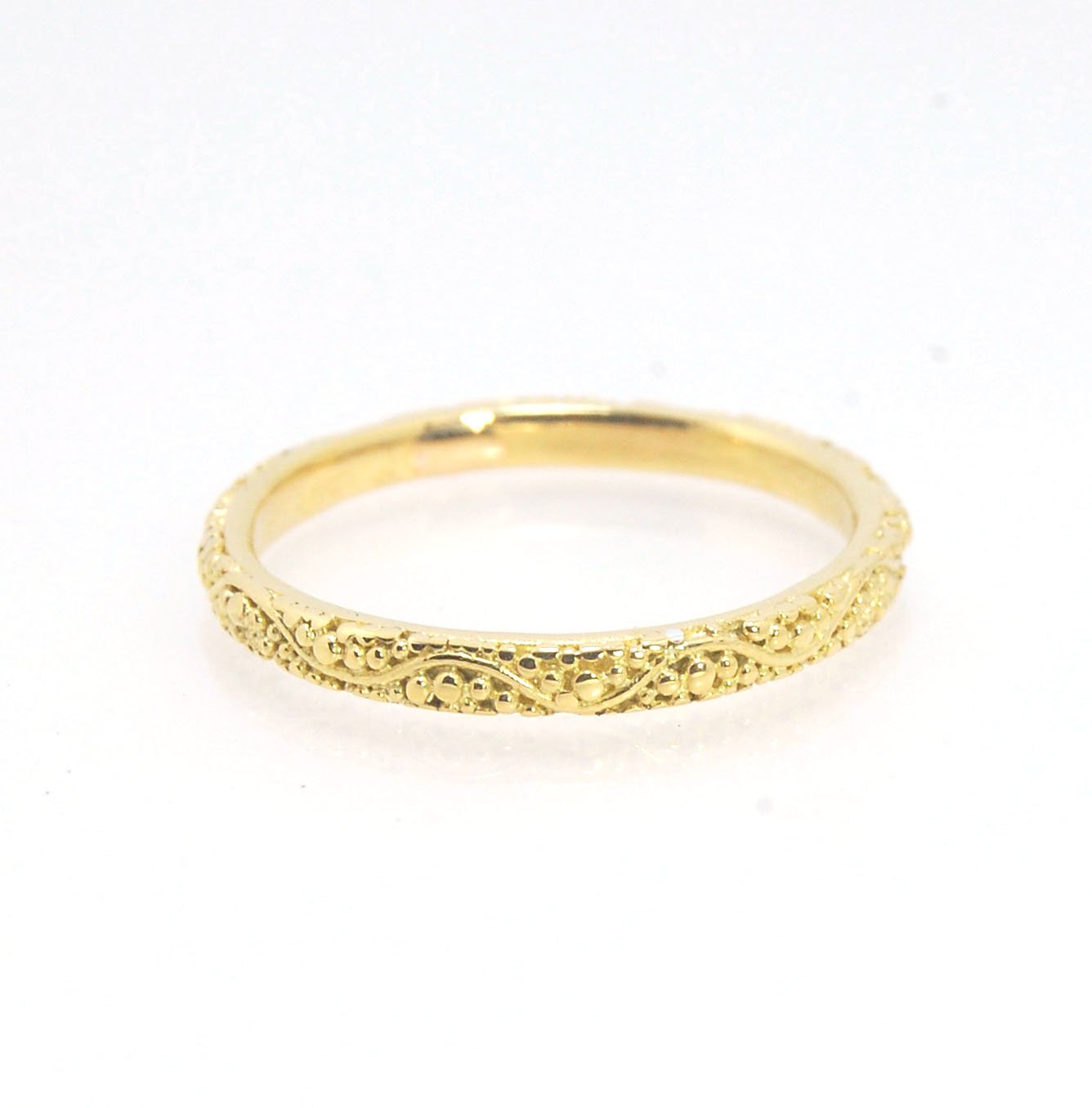 Twining Band in 18k Granulation This is a one-of-a-kind 18k ring handmade using the ancient process of granulation. The twining band is 2mm wide and has a continuous pattern around made with an ancient and unique process of granulation in 18k gold alloyed