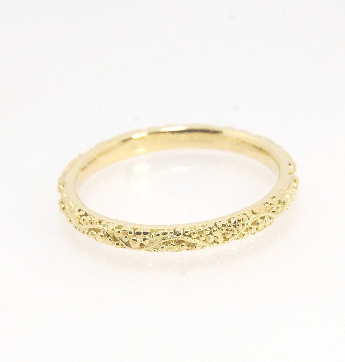 Twining Band in 18k Granulation This is a one-of-a-kind 18k ring handmade using the ancient process of granulation. The twining band is 2mm wide and has a continuous pattern around made with an ancient and unique process of granulation in 18k gold alloyed