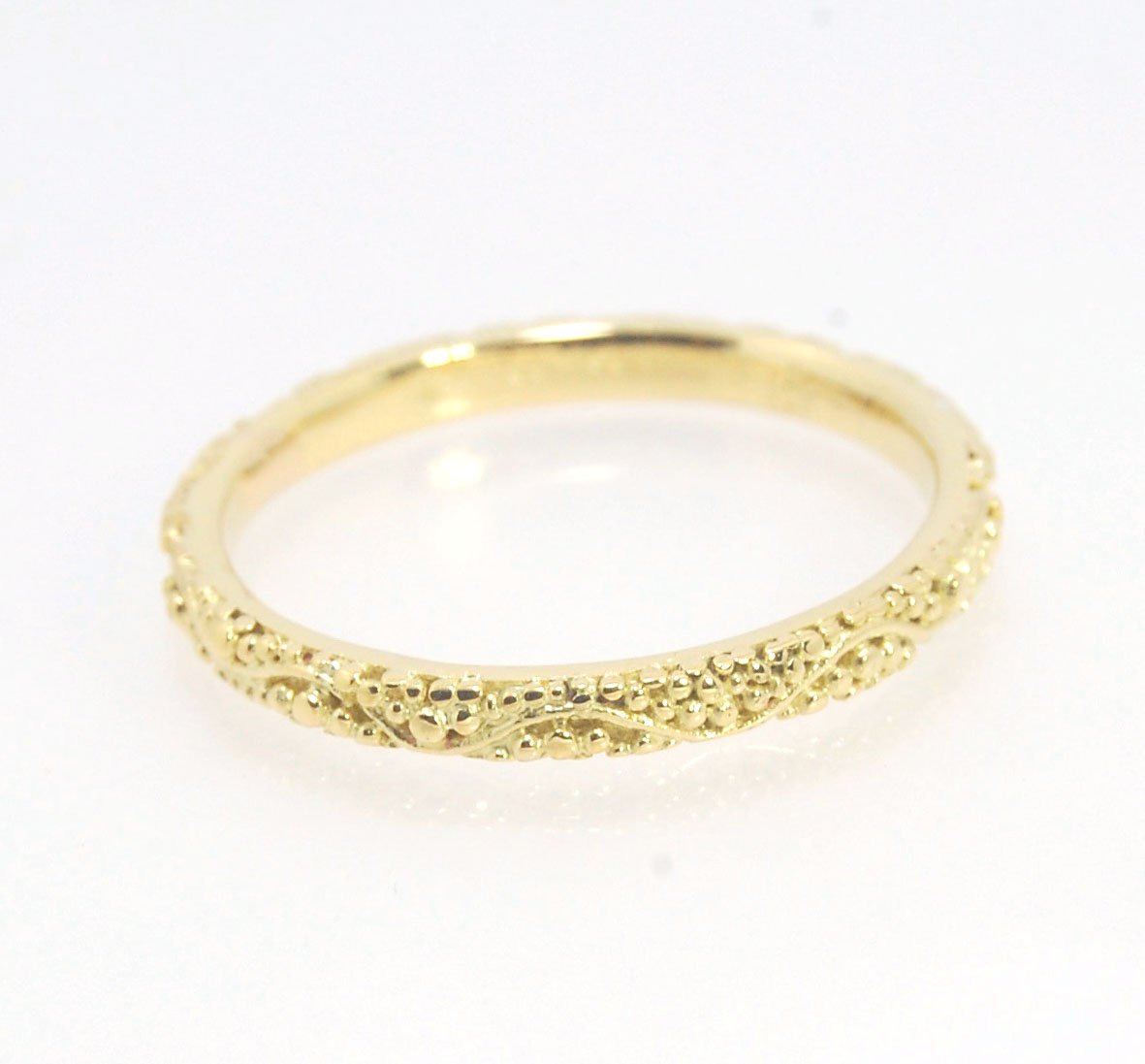 Twining Band in 18k Granulation This is a one-of-a-kind 18k ring handmade using the ancient process of granulation. The twining band is 2mm wide and has a continuous pattern around made with an ancient and unique process of granulation in 18k gold alloyed