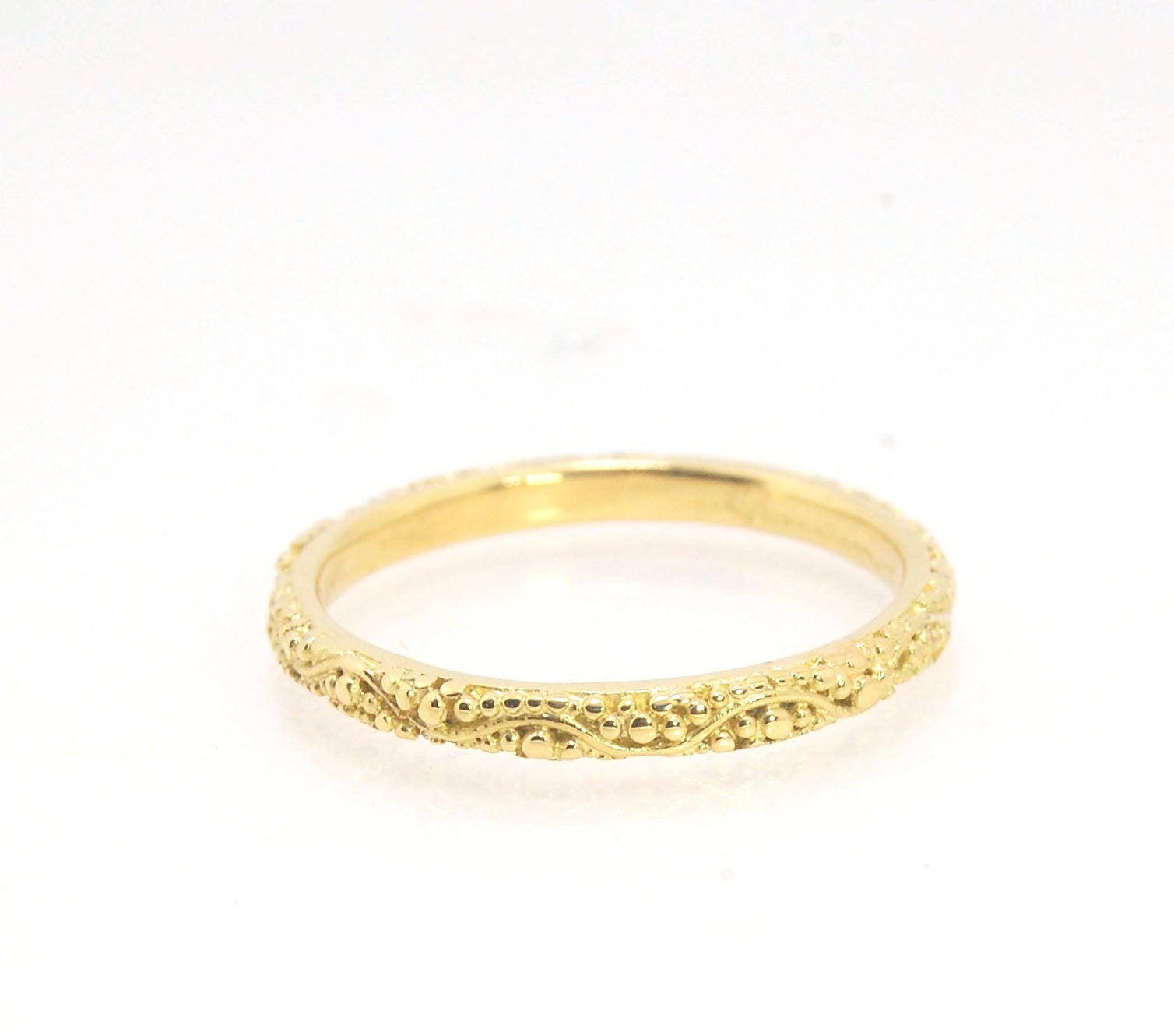 Twining Band in 18k Granulation This is a one-of-a-kind 18k ring handmade using the ancient process of granulation. The twining band is 2mm wide and has a continuous pattern around made with an ancient and unique process of granulation in 18k gold alloyed