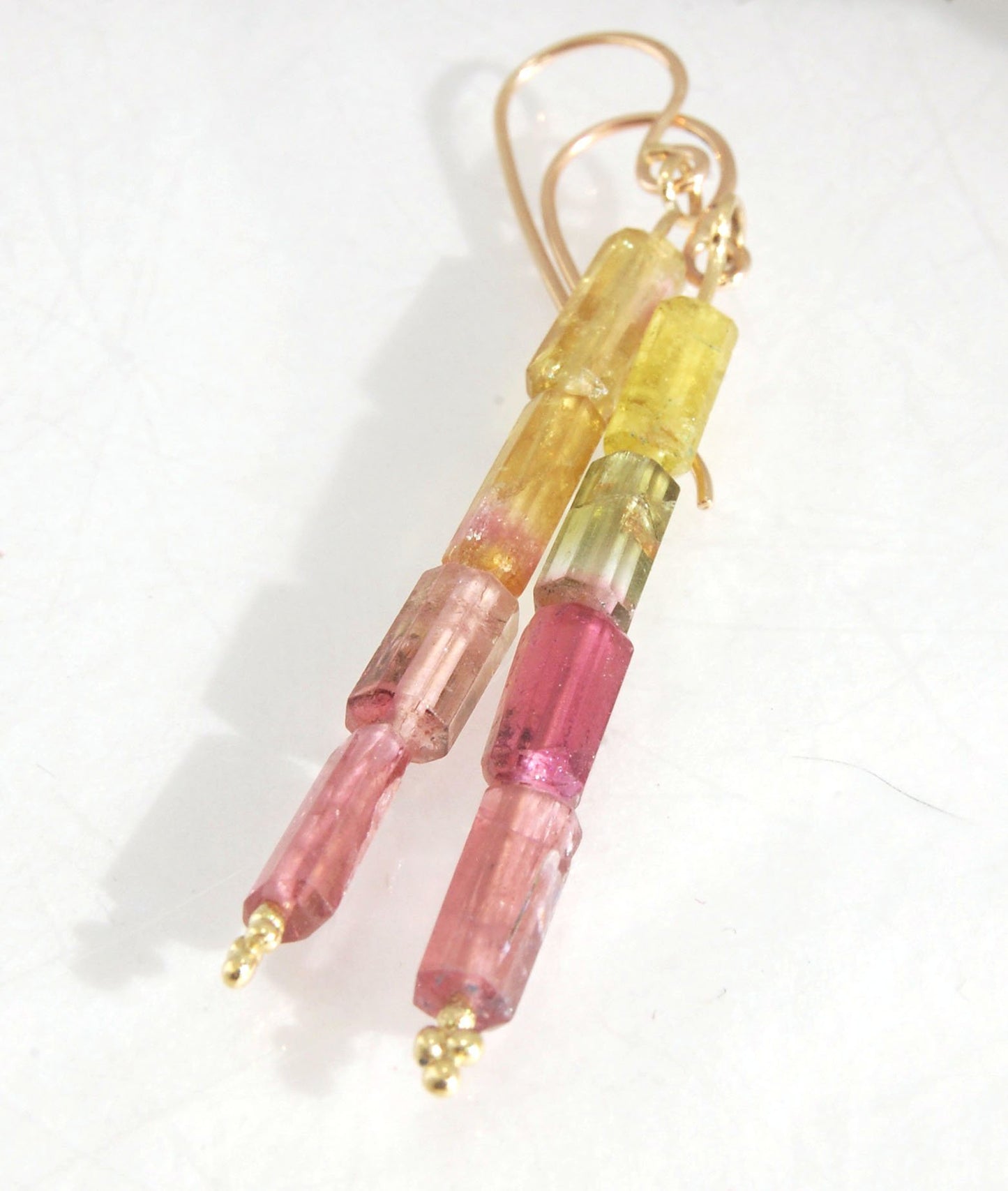 Watermelon Rind Tourmaline Dangle Earrings in 14k gold with french hooks Oh these colors! These Watermelon Rind Tourmaline Dangle Earrings in 14k gold with french hooks are made from faceted slices of natural tourmaline crystals on a 14 pin with 18k spher