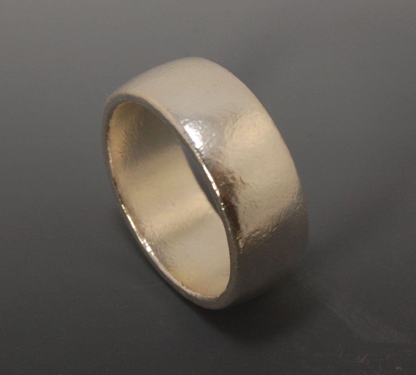 Real Wide Flat Half Round Band Ring in Sterling Silver This is a Real Wide Flat Half Round Band Ring cast from a wax carving. 8mm wide and 2.5mm thick, this ring was turned on a lathe in wax and cast using the lost wax process. These are so much fun to ma