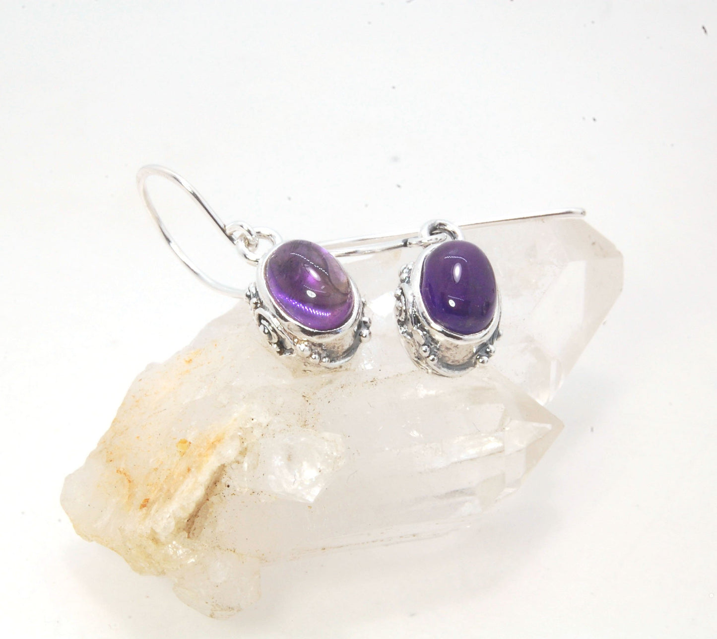 Oval Amethyst Earrings in Swirled silver bezel setting with french hook These are cast in my studio using the ancient technique of lost wax casting, and are molded in wax from an original granulated piece in fine silver. These sweet ovals are reminiscent